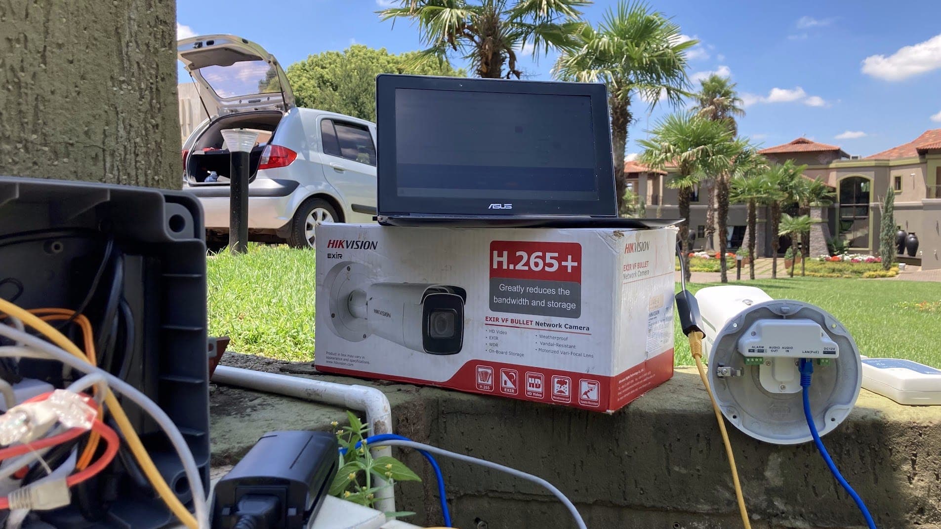 Hikvision bullet camera being set up during a CCTV installation on a residential estate