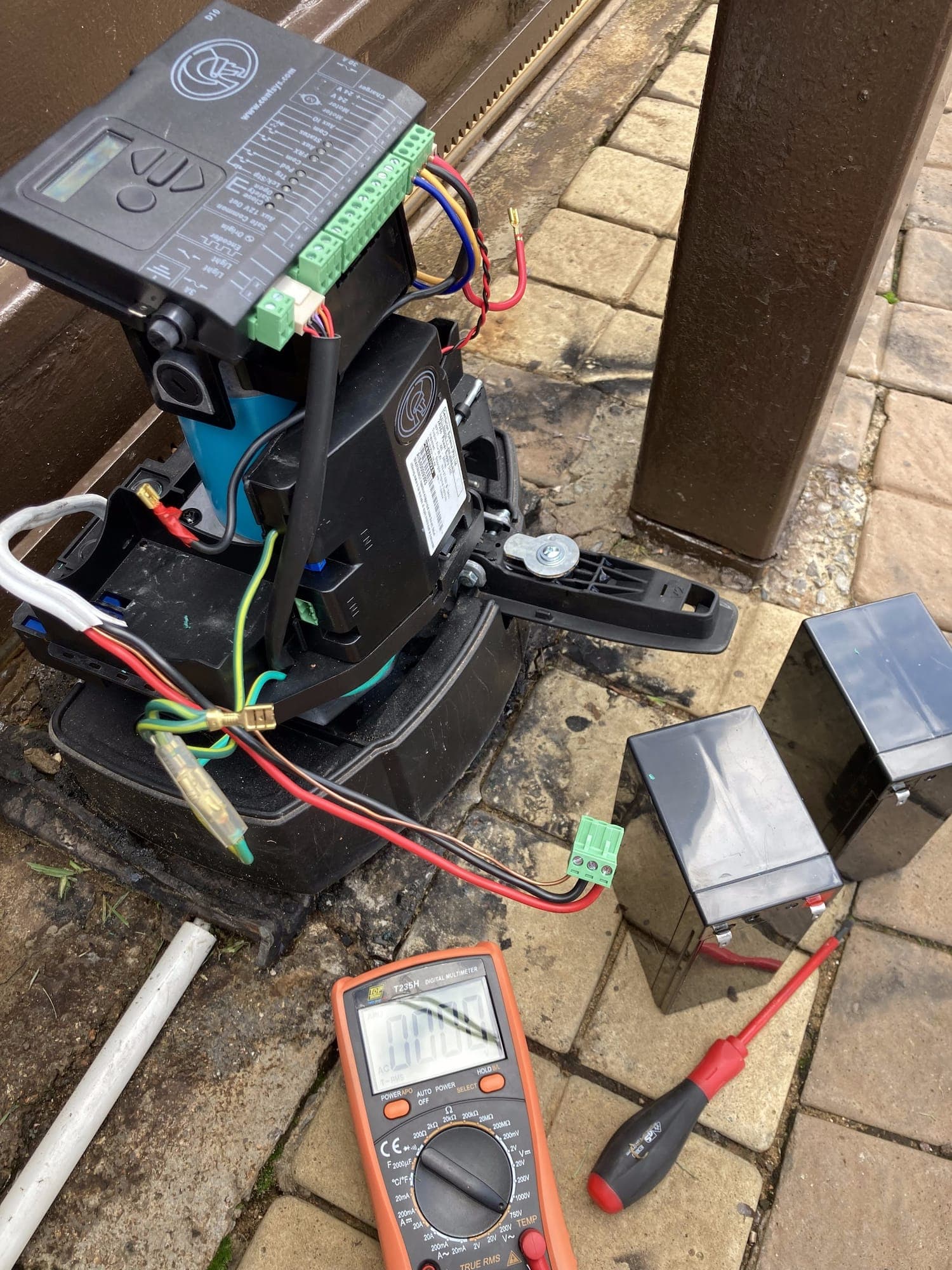 Gate motor controller opened up and tested with a multimeter during on-site fault finding
